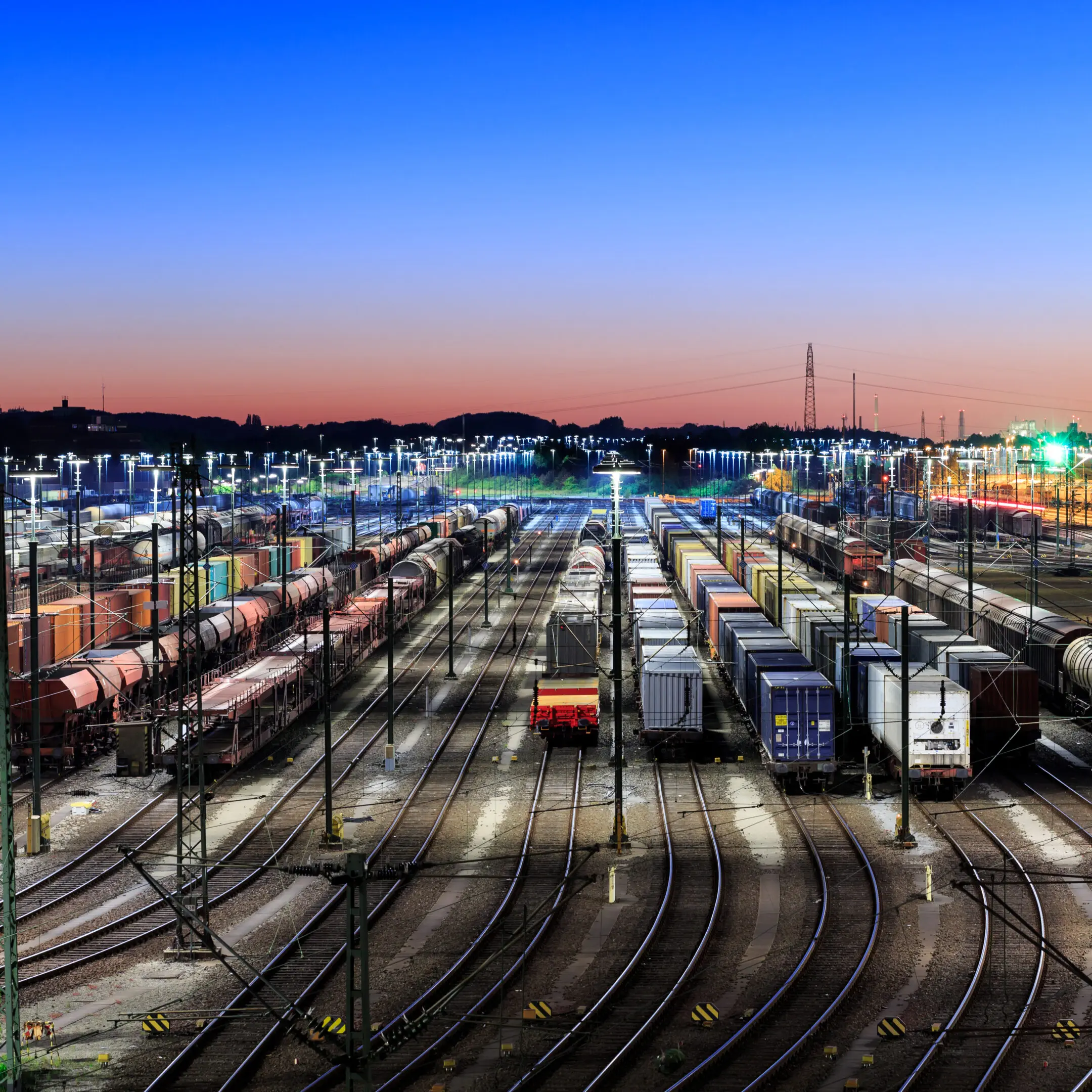 Freight trains parked under evening sky.