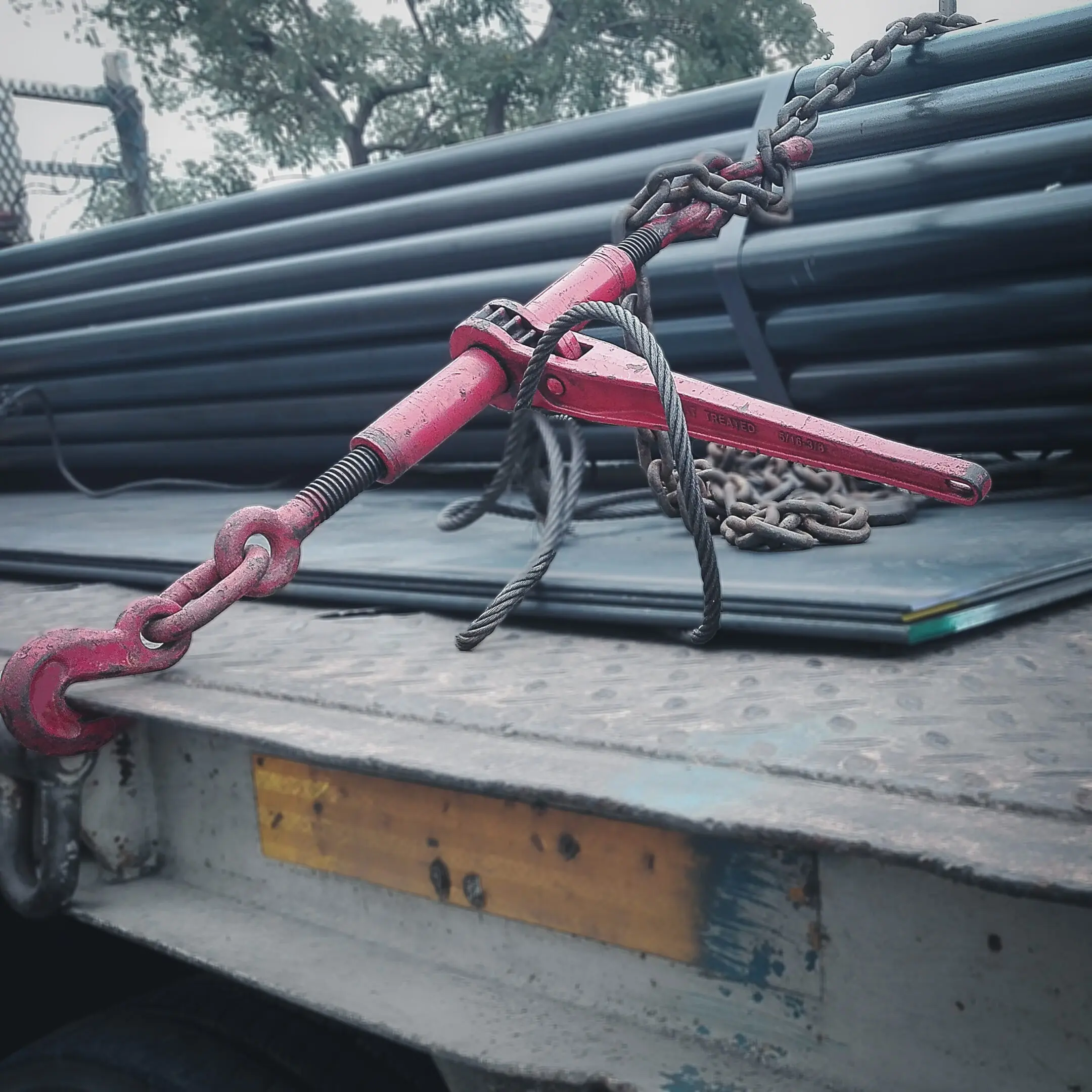 Metal pipes loaded on a flatbed truck.