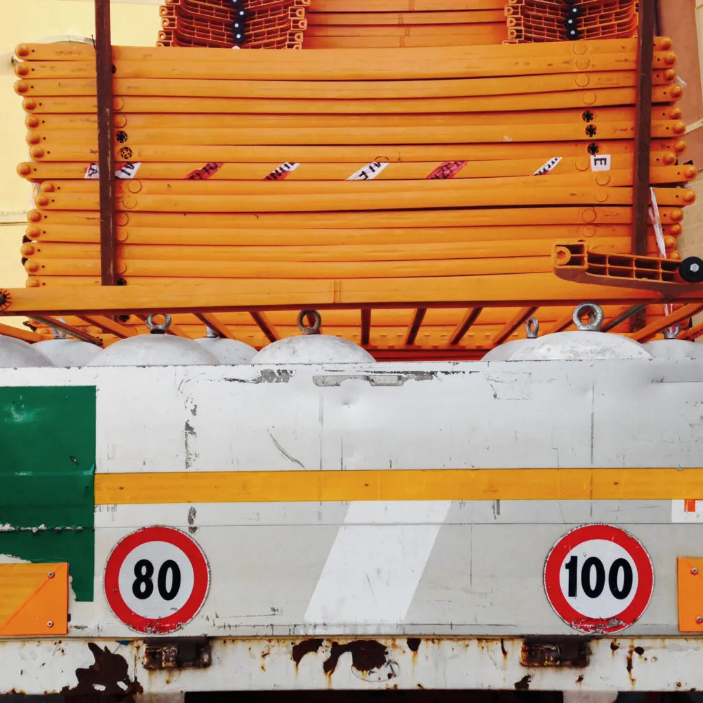 Orange pipes with speed limit signs
