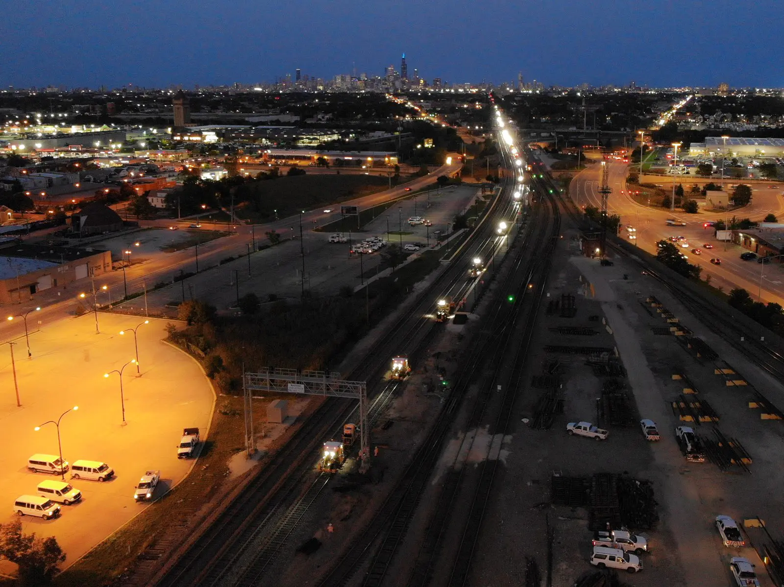 City skyline at night with illuminated roads.