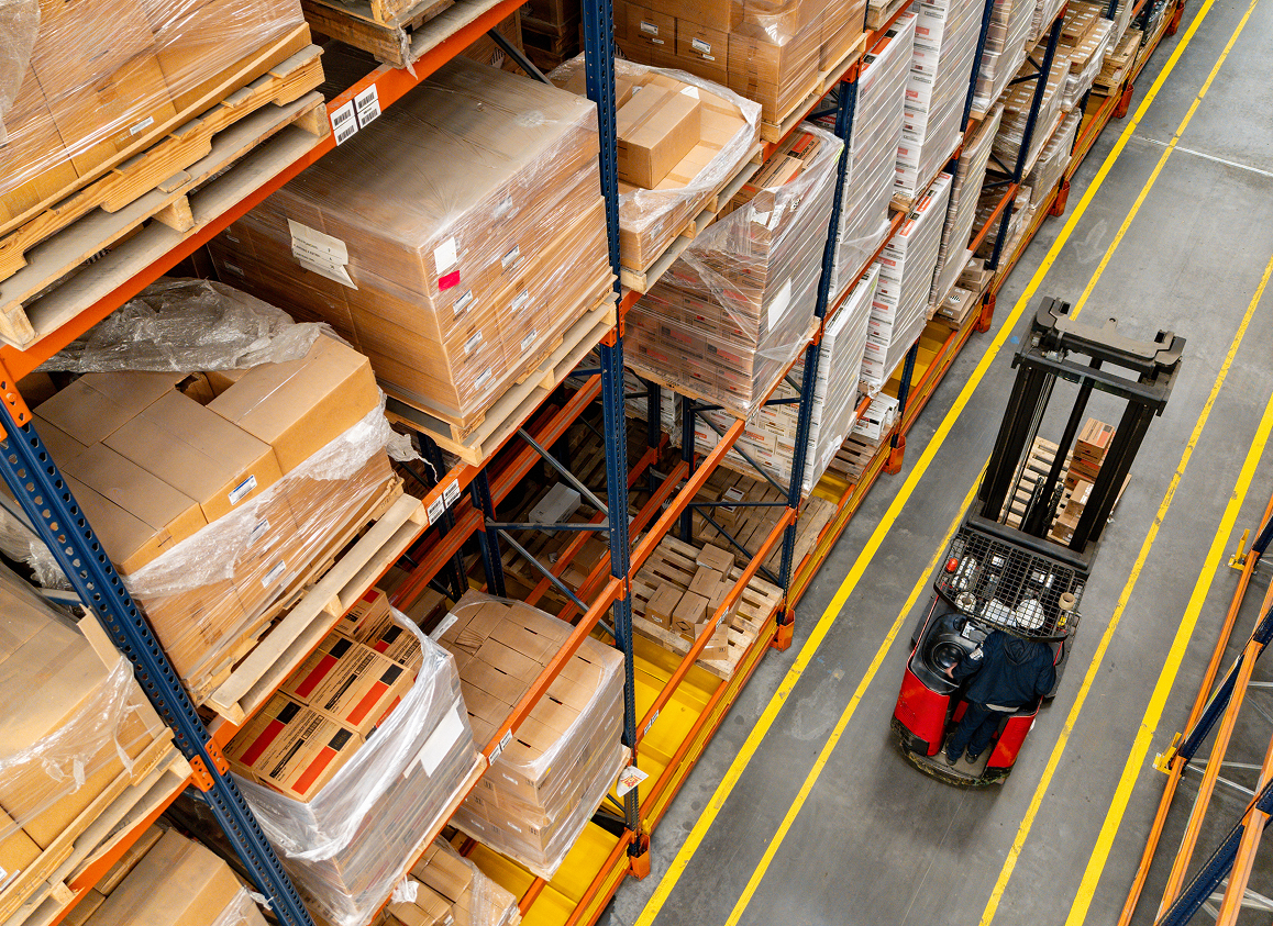 Forklift moving through warehouse aisles