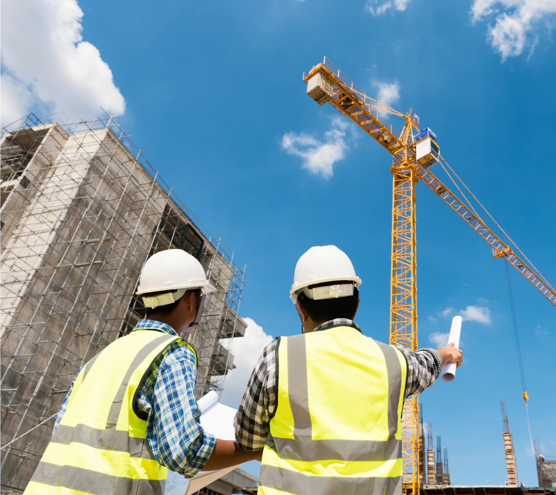 Construction workers reviewing building plans