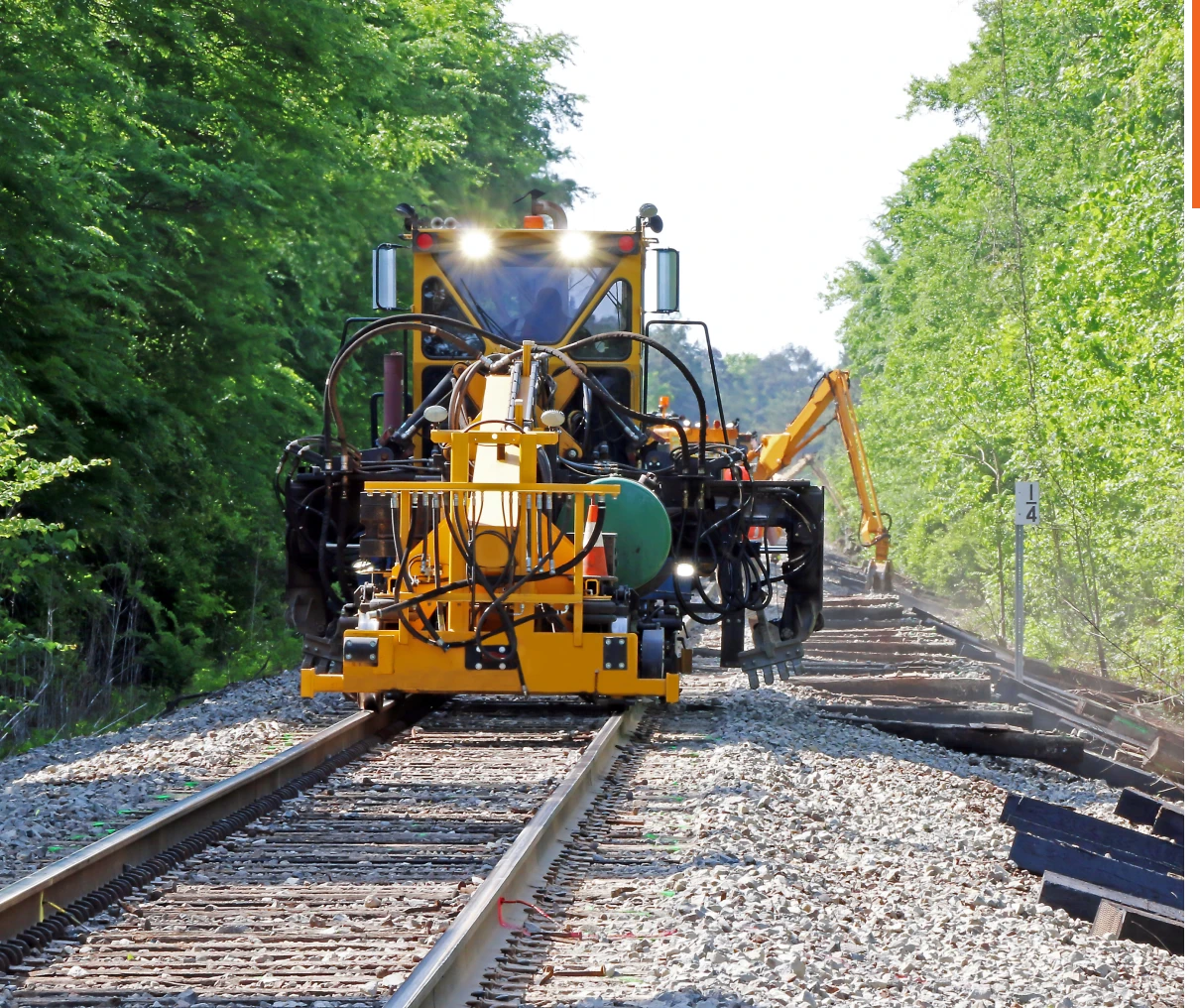 Yellow machine repairing railway tracks